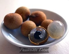 a white plate topped with kiwis and an orange on top of a table