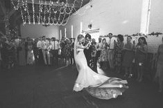 a bride and groom dancing in front of their guests