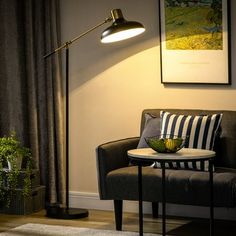 a living room scene with focus on the table lamp and chair, along with a striped throw pillow