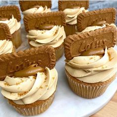 several cupcakes with frosting and peanut butter on top sitting on a plate