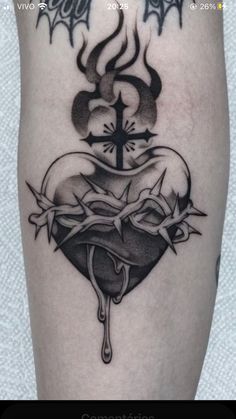 a black and white photo of a heart with a cross on it's side