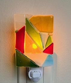 a colorful light switch cover on a white wall