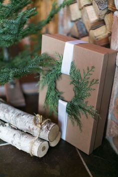 a christmas tree with two wrapped presents next to it