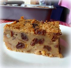 a piece of cake sitting on top of a white plate next to a red and white checkered table cloth