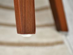 a close up view of a wooden object hanging from the ceiling