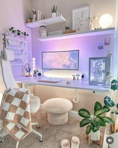 a desk with a computer on it in a room filled with plants and other items