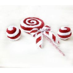 red and white lollipops are sitting next to each other