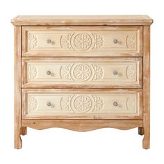 a white wooden dresser with carvings on the top and bottom drawer, against a white background