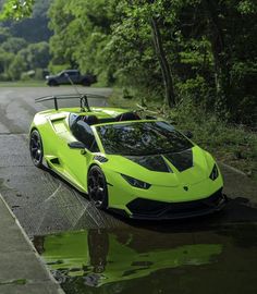 a yellow sports car is parked on the side of the road