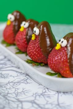 three chocolate covered strawberries in the shape of birds