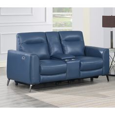 a blue leather reclining loveseat in a living room