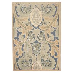 a blue and beige rug with an ornate design