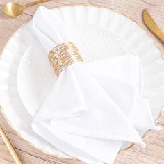 a white plate topped with napkins and goldware