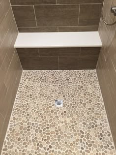 a tile floor in a bathroom with the words glazed javean pebble tile