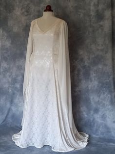 Medieval Wedding Dress, Elvish Wedding Dress, Handfasting Dress, Elvish Gown,  Renaissance Gown, Medieval Gown, Grace FREE TRACKABLE AND INSURED SHIPPING frockfollies is proud to add this beautiful new design to the collection. Grace is pictured in ivory guipure lace over satin and ivory crushed velvet. With it's elegant V shaped front and back neckline Grace is complimented by elegant flowing chiffon sleeves and back lacing. It has a really romantic, elegant feel.  The train can be made shorter at no extra cost. It is designed and custom made by Gill Linley of frockfollies. Perfect for so many occasions: Medieval, Renaissance, Elvish Weddings, Hand Fasting ceremonies, LARP events, Re Enactments, Masquerade Balls or your 'inner goddess' moments! Hand made in England by an experienced theat Elvish Wedding Dress, Wedding Dress Medieval, Elvish Dress, Handfasting Dress, Elvish Wedding, Elven Wedding Dress, Medieval Wedding Dress, Dress Medieval, Medieval Gown