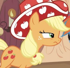 the pony is wearing a red hat with hearts on it