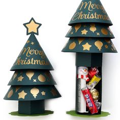 two cardboard christmas trees with gold stars on them