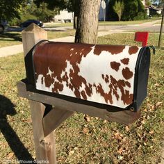 a mailbox with brown and white cow print on it