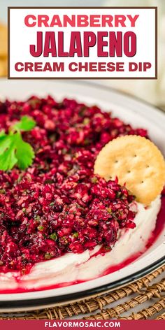 cranberry jalapeno cream cheese dip on a plate with crackers