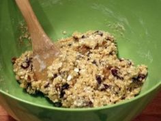 a green bowl filled with oatmeal and raisins