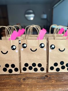 small bags with faces drawn on them sitting on a table