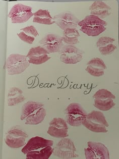 an open notebook with pink lipstick on it and the words dear diary written in cursive writing