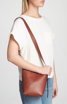 Madewell's newest leather bag collection is cool, modern and quietly luxe. With a magnetic closure and interior pocket, the mini bucket tote is perfectly sized to hold your phone, wallet, keys and more—plus, it has a shoulder strap and adjustable crossbody strap. It's so good, it's essential. Structured silhouette with flat base for stability Leather Imported Brown Smooth Grain Bucket Bag For Work, Cognac Bucket Bag With Removable Pouch For Work, Versatile Bucket Bag With Smooth Grain For Everyday Use, Bucket Bag With Cell Phone Pocket, Modern Smooth Grain Bucket Bag For Everyday Use, Minimalist Bucket Bag For Travel, Classic Smooth Grain Bucket Bag For Work, Versatile Smooth Grain Crossbody Bucket Bag, Cognac Smooth Grain Bucket Bag For Everyday