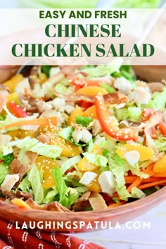 chicken salad with lettuce, carrots and peppers in a bowl on a table