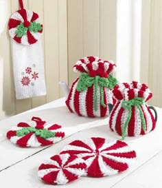 crochet christmas decorations on a table with candy canes and peppermints