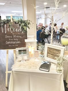 a table that has some signs on it and candles in front of the tables are decorated with flowers