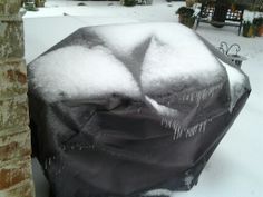 there is a covered grill in the snow