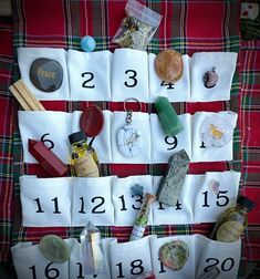 a table topped with lots of different items on top of a red and green blanket