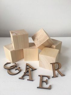 wooden letters spelling out the word fear on a white surface with other wood blocks and letters