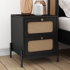 a black nightstand with wicker baskets on top