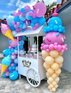 an ice cream cart is decorated with balloons