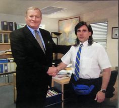 two men are shaking hands in an office