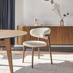 a white chair sitting in front of a wooden table