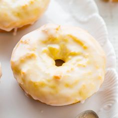 three glazed donuts on a white plate