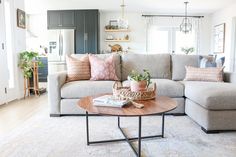 a living room filled with furniture and lots of pillows on top of a coffee table