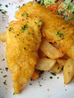 fish and chips on a plate with coleslaw