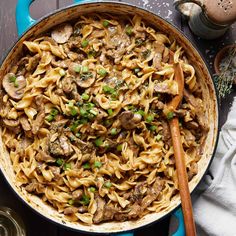 a skillet filled with pasta and mushrooms