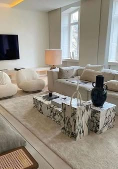 a living room filled with furniture and a large flat screen tv mounted on the wall