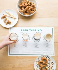 the beer tasting menu is displayed with pretzels in glasses and plates on the table