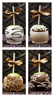 four different types of chocolate covered apples with gold bows on them and ribbons tied to them