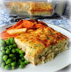 a white plate topped with food next to green peas