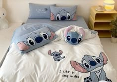 a bed with two pillows on top of it and an image of the same cartoon character