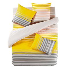 a bed with yellow, grey and white striped comforter sets on top of it