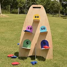 two wooden boards with numbers on them in the grass