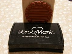 there is a stamper on top of a table that says versa mark watermark stamp pad