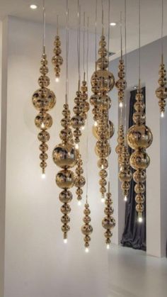 some gold balls hanging from the ceiling in a room